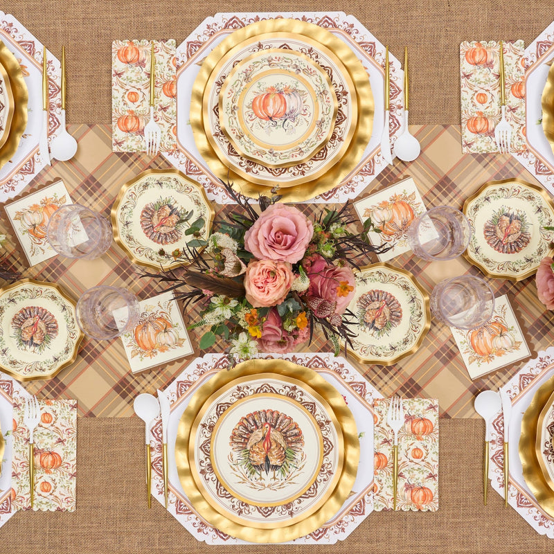Sure! Here’s the revised sentence using your provided product data: Celebrate Thanksgiving in style with the Turkey & Gourds Table Setting by Sophistiplate, a fall-themed party-in-a-box that includes designer disposable plates adorned with turkeys and pumpkins, gold chargers, a floral centerpiece featuring pink roses, a plaid tablecloth, and matching napkins—all beautifully coordinated to create stunning Thanksgiving table decor when viewed from above.