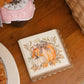 Turkey & Gourds Cocktail Napkins/26pk, featuring scalloped edges and an illustration of gourds with a plaid bow.