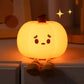 Cute Pumpkin Night Light with a face on a shelf.