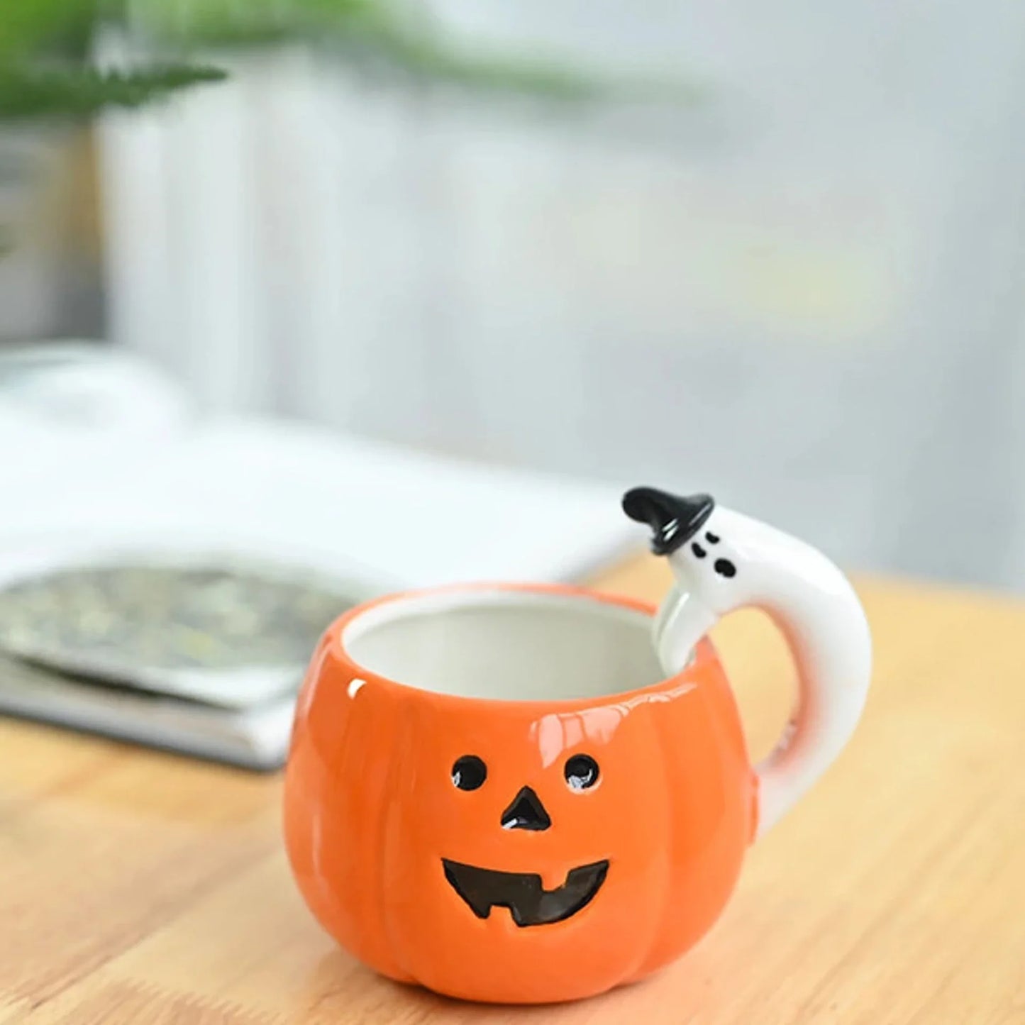 Ceramic Pumpkin Mug with Ghost Handle and Halloween Theme Design