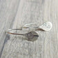 Shimmering sterling silver teardrop dangle earrings for women with intricate dandelion design. Elegant and unique jewelry.