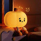 Cute Pumpkin Night Light with a sleeping expression on a soft surface.