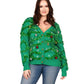 Woman wearing a green Christmas tree-themed sweater on a white background